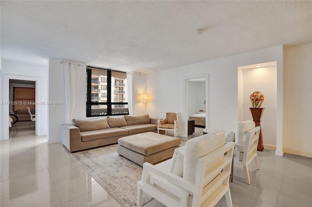 living room with a textured ceiling and light tile patterned floors