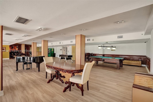 dining area with billiards and light hardwood / wood-style floors