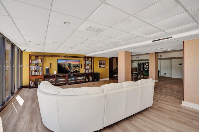 living room featuring hardwood / wood-style flooring and a paneled ceiling