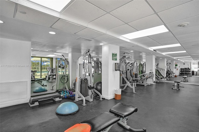 exercise room with a paneled ceiling