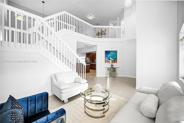 tiled living room featuring a towering ceiling