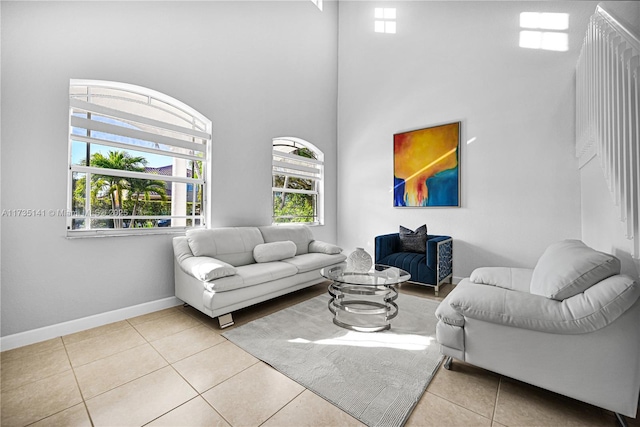 tiled living room with a towering ceiling