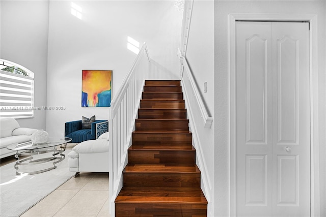 staircase featuring tile patterned flooring