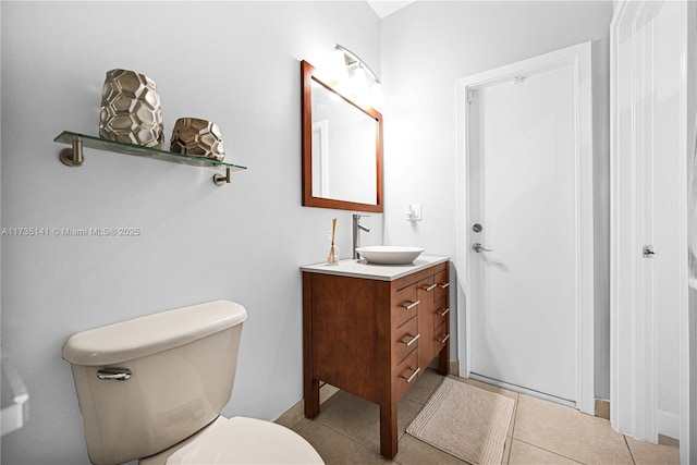 bathroom with tile patterned flooring, vanity, and toilet