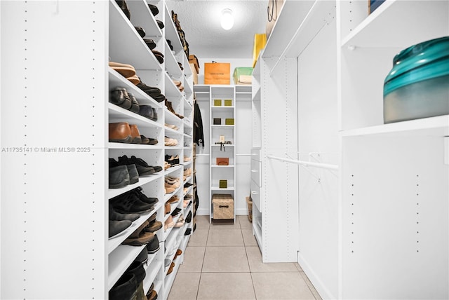 walk in closet featuring light tile patterned flooring