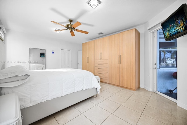 tiled bedroom featuring ceiling fan