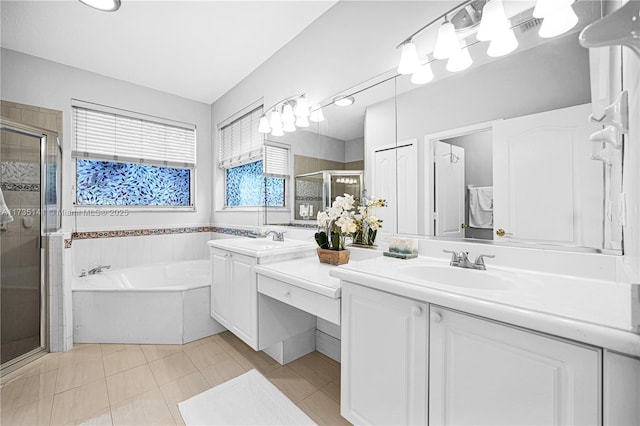 bathroom featuring shower with separate bathtub, vanity, and tile patterned floors