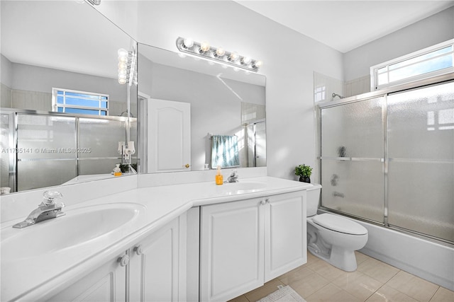 full bathroom with tile patterned floors, vanity, toilet, and combined bath / shower with glass door