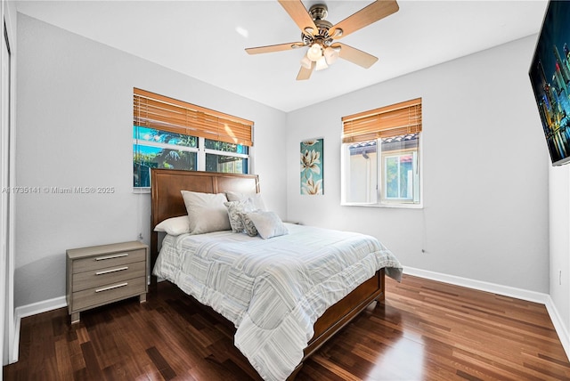 bedroom with dark hardwood / wood-style floors and ceiling fan