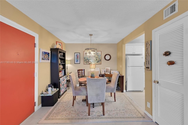 dining area featuring a textured ceiling