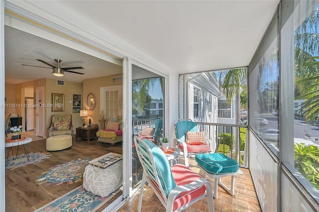 sunroom featuring plenty of natural light and ceiling fan