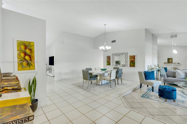 dining area with a notable chandelier, high vaulted ceiling, and light tile patterned floors