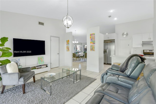 tiled living room featuring a notable chandelier