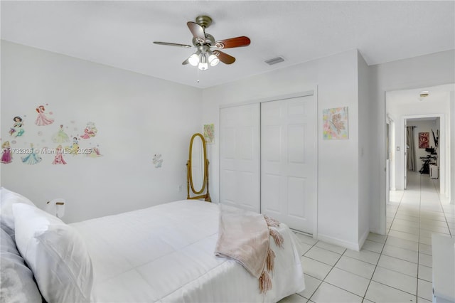 tiled bedroom with a closet and ceiling fan