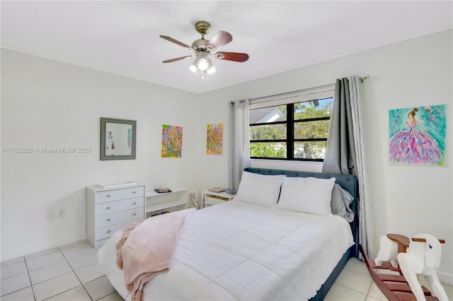 tiled bedroom featuring ceiling fan