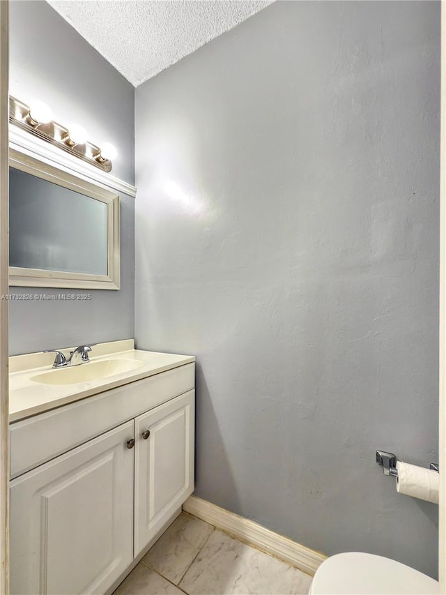 bathroom with vanity and a textured ceiling