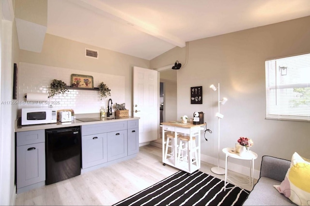 kitchen with sink, vaulted ceiling with beams, refrigerator, light hardwood / wood-style flooring, and gray cabinets