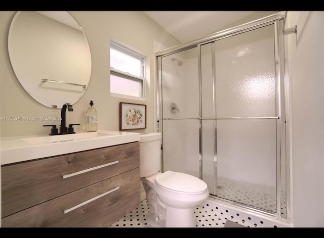 bathroom with vanity, an enclosed shower, and toilet