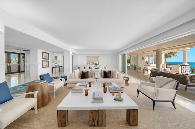 living room featuring a healthy amount of sunlight and a water view