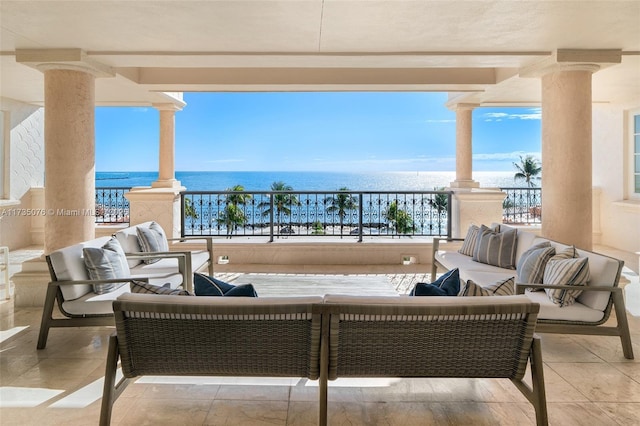 view of patio / terrace with a water view, a balcony, and an outdoor hangout area