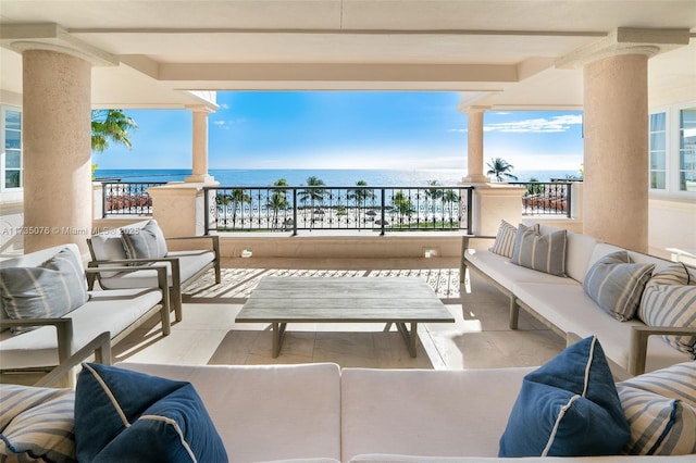 view of patio with a water view, a balcony, and outdoor lounge area