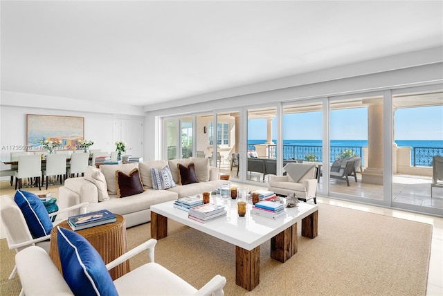 living room with tile patterned flooring and a water view