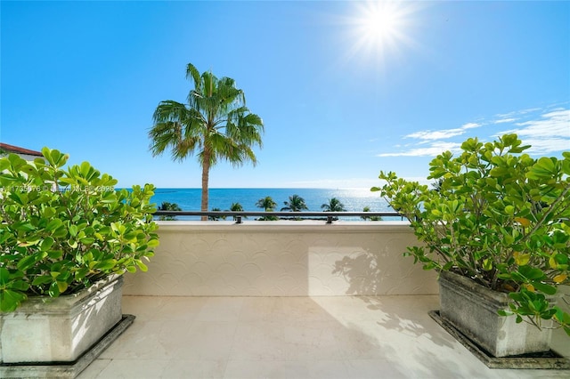 view of patio / terrace featuring a water view and a balcony