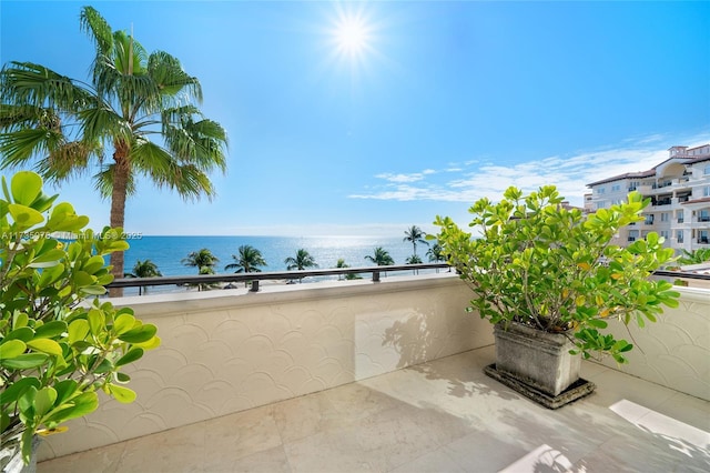 view of patio / terrace featuring a water view and a balcony