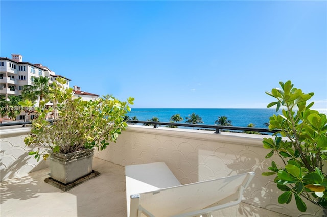 view of patio / terrace with a water view and a balcony