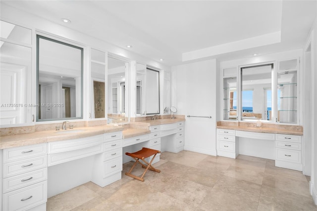 bathroom with vanity and a raised ceiling