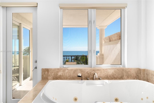 bathroom with a water view and a washtub