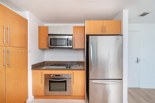 kitchen with stainless steel appliances and light hardwood / wood-style flooring