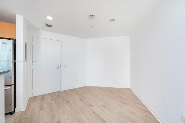 spare room featuring light wood-type flooring