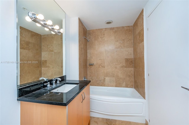 bathroom with vanity and tiled shower / bath