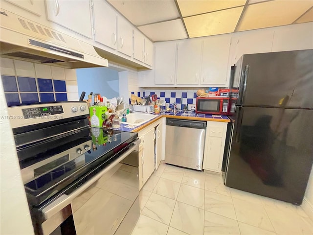 kitchen featuring white cabinetry, stainless steel appliances, sink, and tasteful backsplash