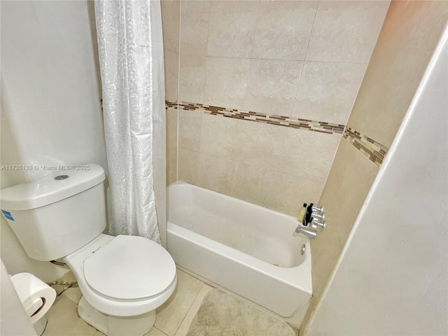 bathroom featuring shower / bathtub combination with curtain, tile patterned floors, and toilet