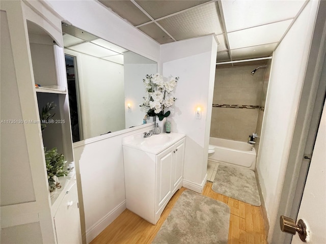 full bathroom featuring vanity, hardwood / wood-style floors, toilet, and tiled shower / bath