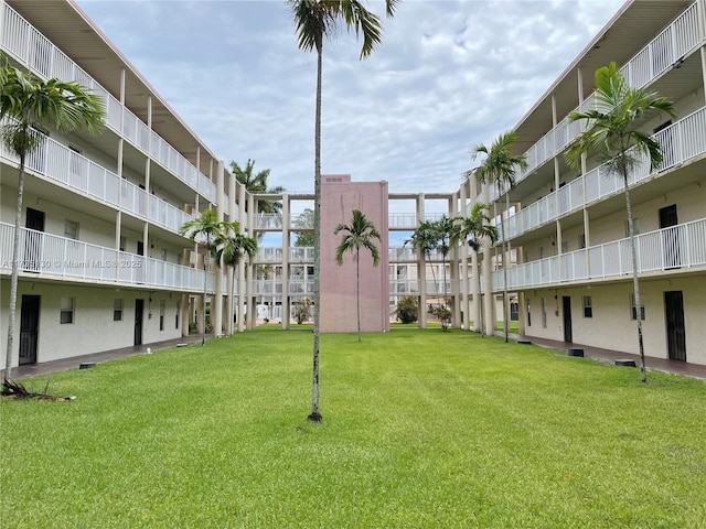 view of property's community with a lawn