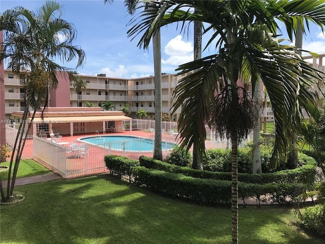 view of pool featuring a patio and a lawn