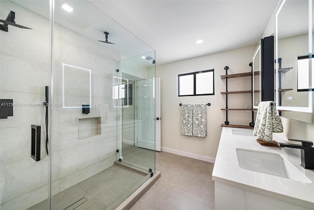 bathroom with an enclosed shower, vanity, and tile patterned floors