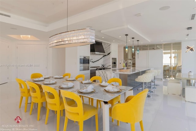 dining space featuring sink and a wall of windows