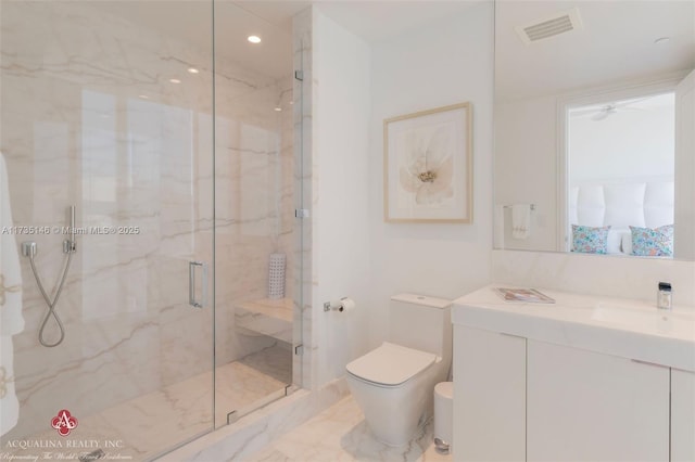 bathroom featuring vanity, toilet, and a shower with shower door