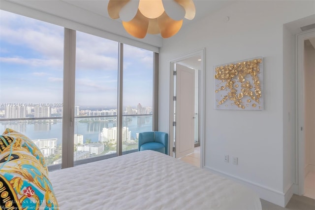 bedroom featuring a water view and ceiling fan