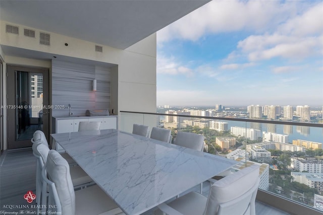 balcony with a water view and sink