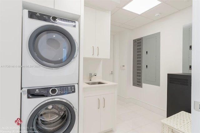 clothes washing area featuring cabinets, stacked washer and clothes dryer, electric panel, and sink