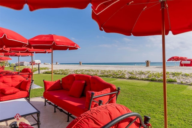 view of patio / terrace with a beach view and a water view