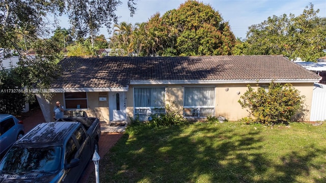 ranch-style house with a front lawn