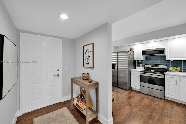 kitchen featuring white cabinetry, dark wood-type flooring, and stainless steel appliances