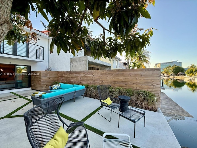 view of patio with an outdoor living space and a water view