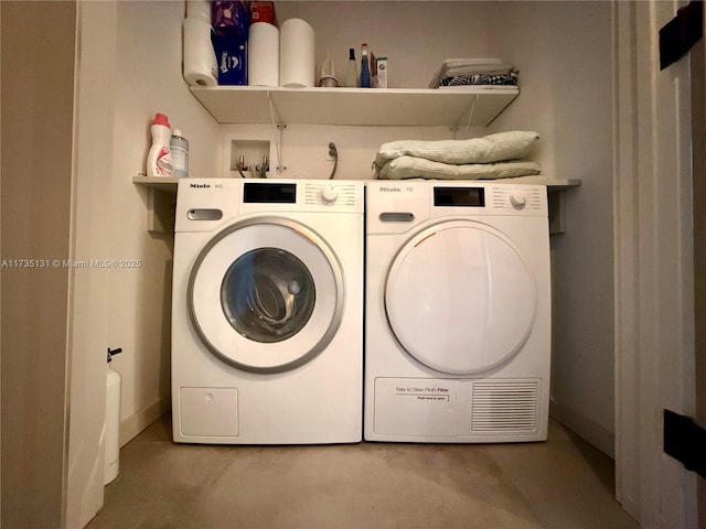 washroom with washing machine and dryer